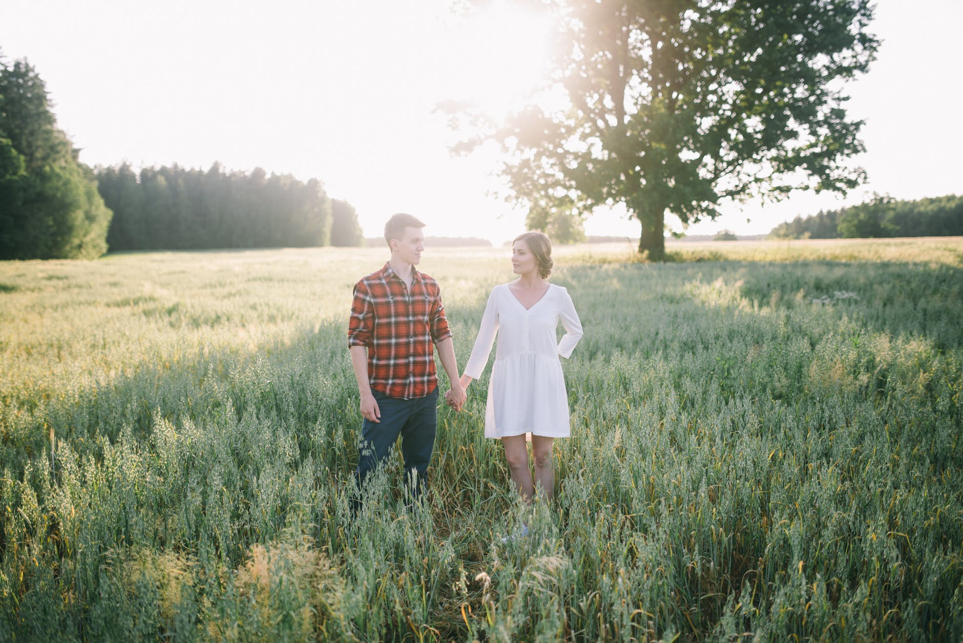 romantic young couple in green field